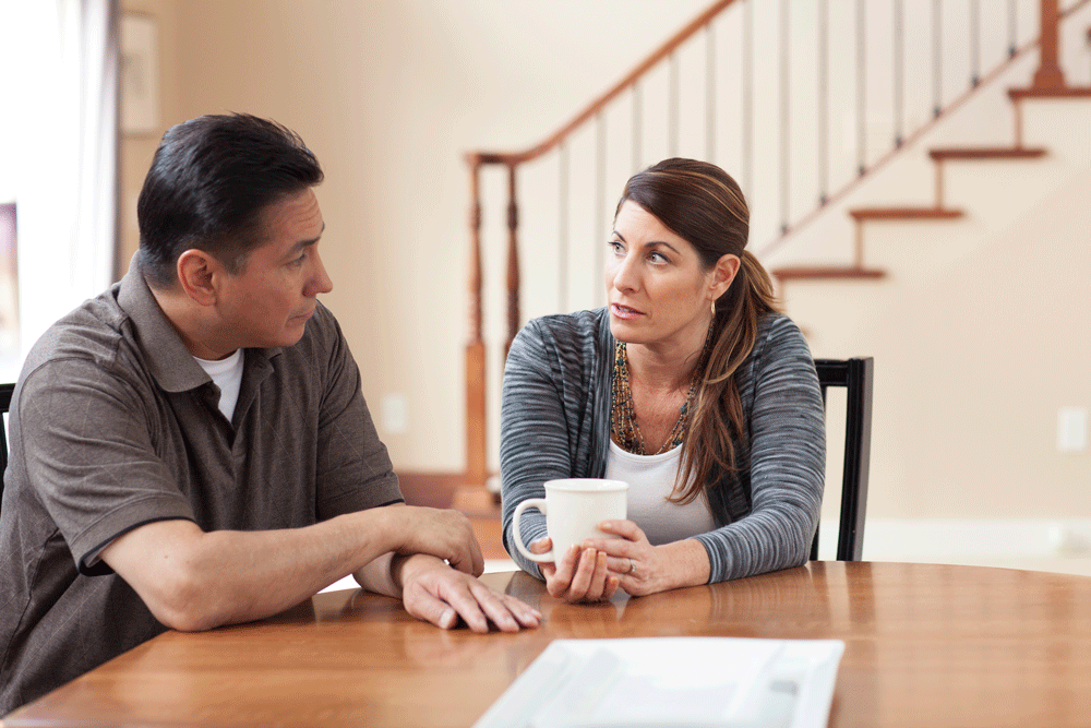 couple-sit-at-kitchen-table