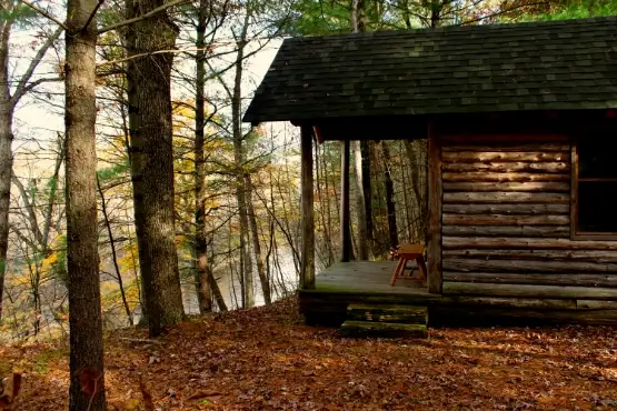 Exterior of a log cabin with an open porch