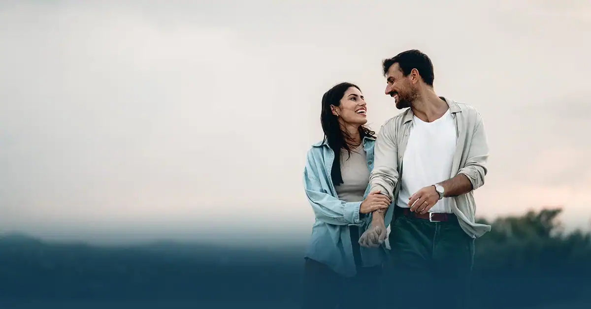 Smiling couple walking outdoors together, Marriage Getaways, a Christ-centered weekend retreat by Focus on the Family